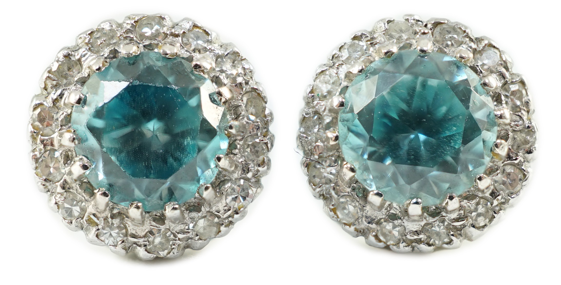 A pair of 18k white gold, blue zircon and diamond set circular cluster ear studs